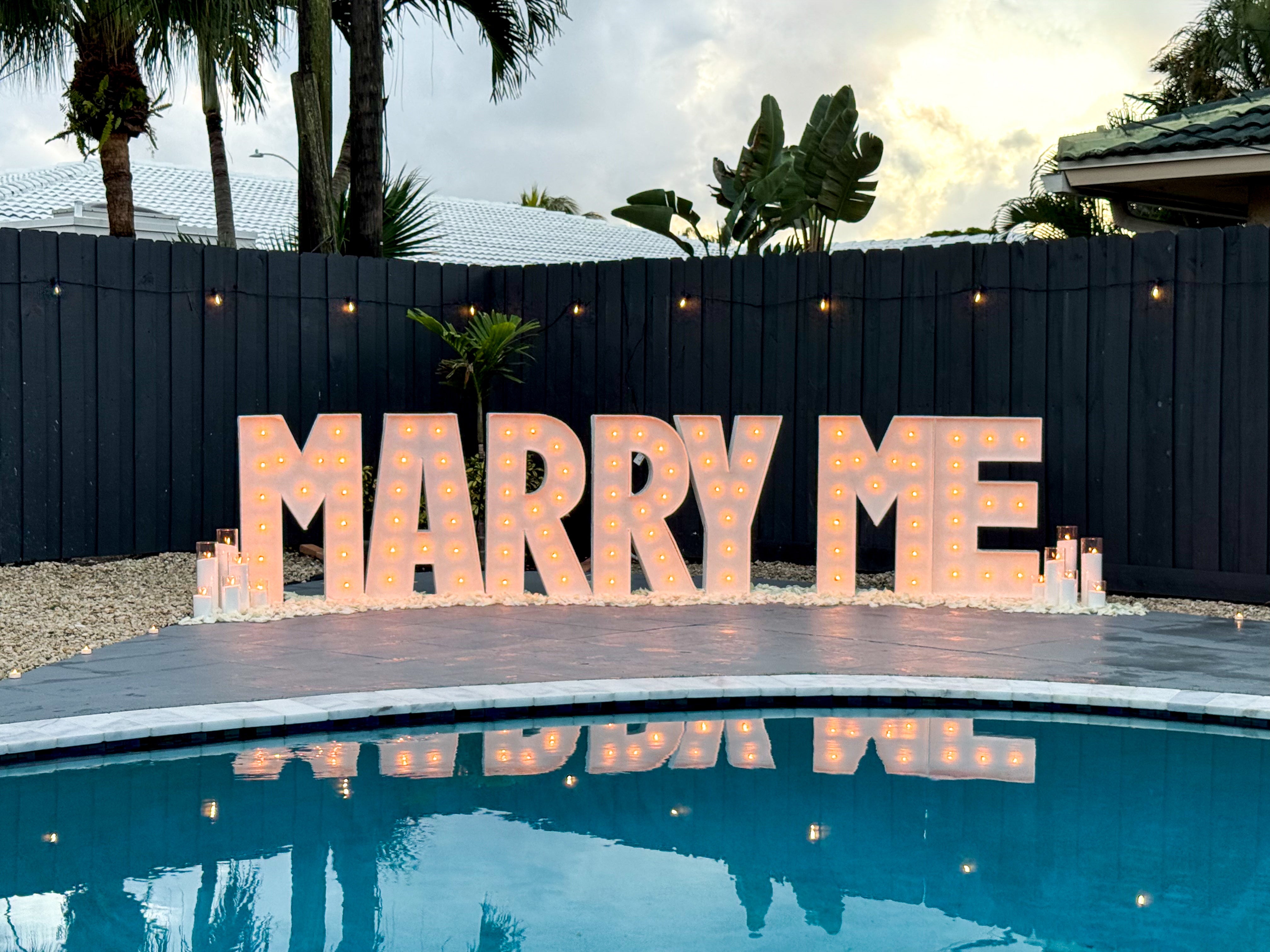 Large 3 ft 'MARRY ME' sign with lights by a poolside. Marquee Letters Proposal Package in Miami, Fort Lauderdale, Palm Beach